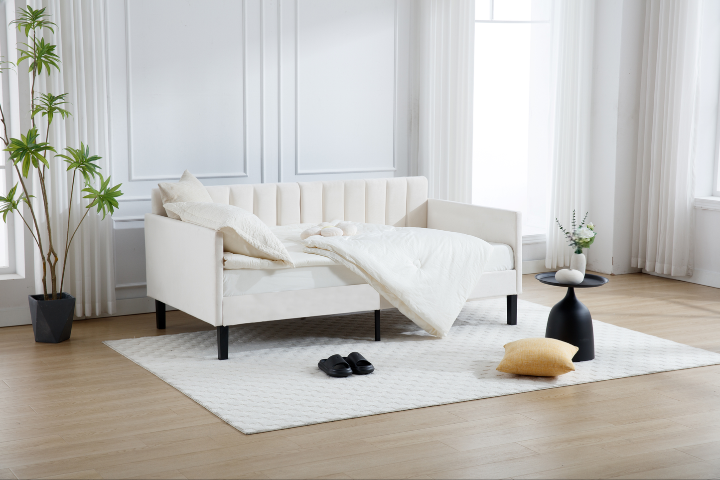 White velvet daybed with channel tufting and black legs