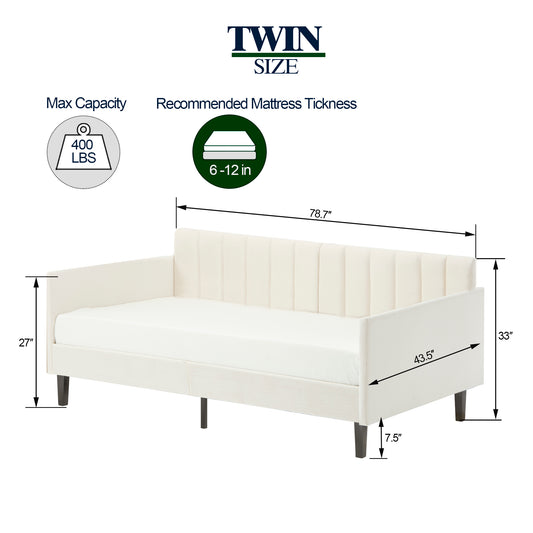 Cream velvet twin size daybed with vertical channel tufting and dark wood legs