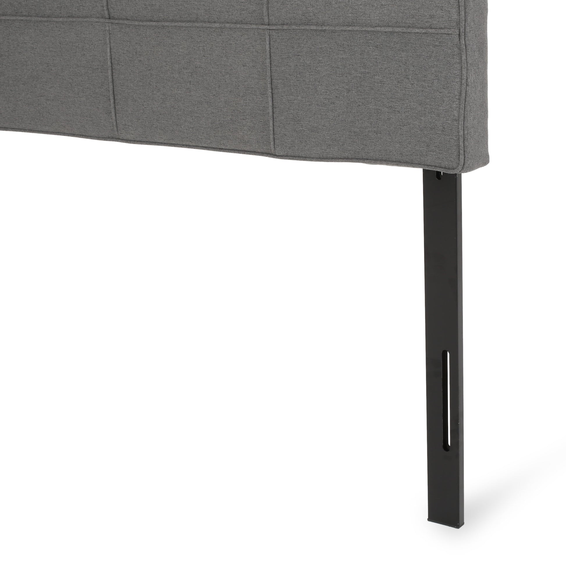 Tufted grey fabric headboard detail with black metal support leg