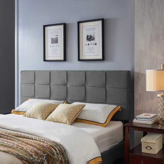 Gray upholstered bed frame with tufted headboard and patterned pillows
