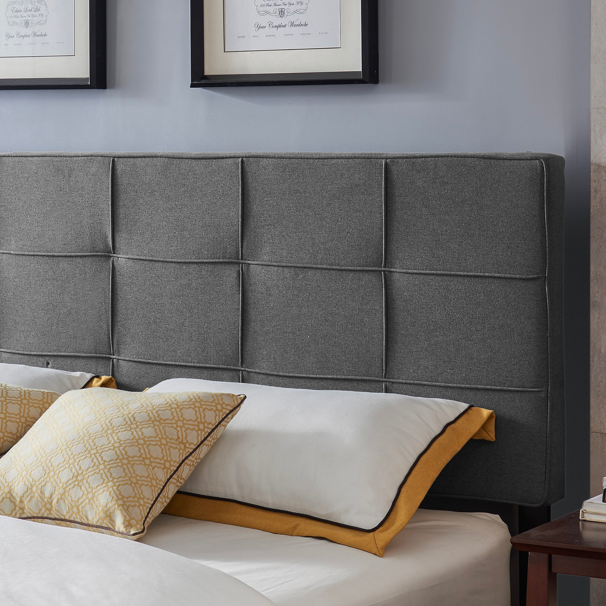 Dark grey upholstered headboard with a modern tufted design perfect for a bedroom
