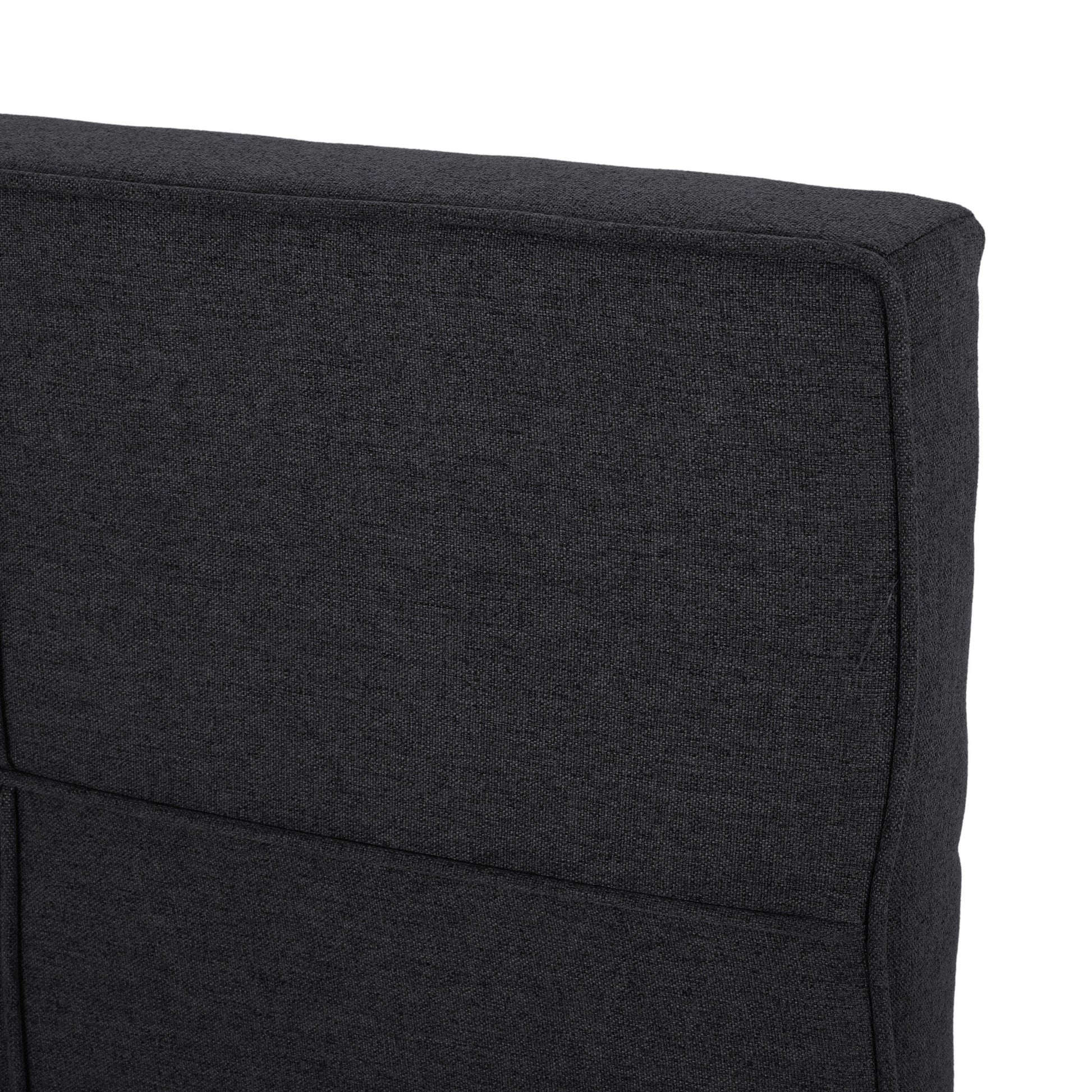 Dark charcoal fabric texture on a modern sofa cushion