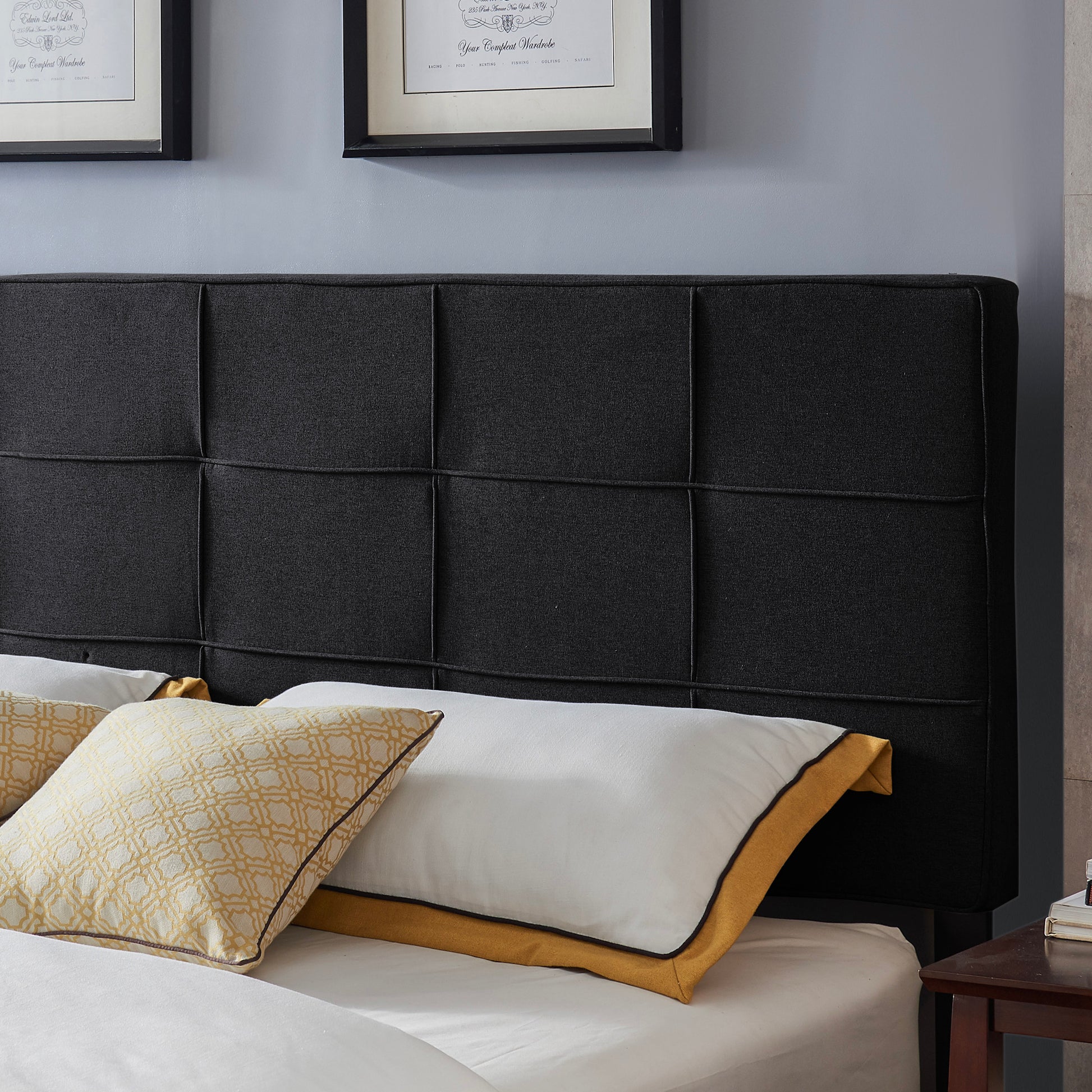 Dark grey upholstered headboard with modern square stitching detail