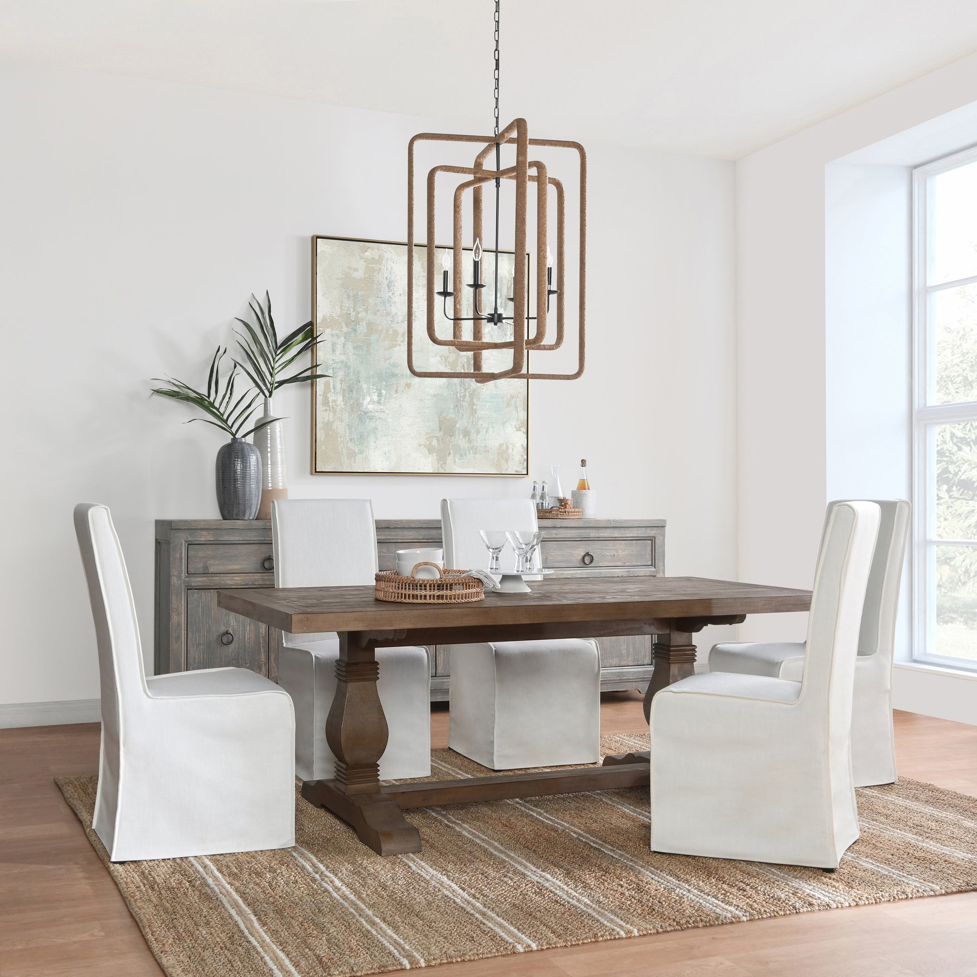 Rustic wooden farmhouse dining table with slipcovered chairs