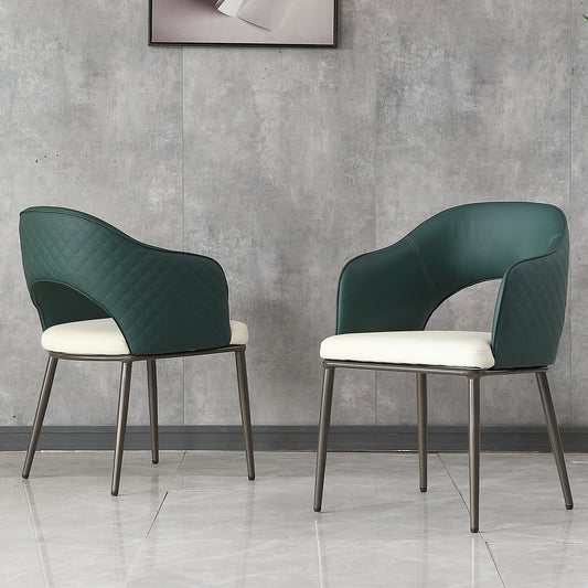 Two emerald green dining chairs with quilted detail and cream seats