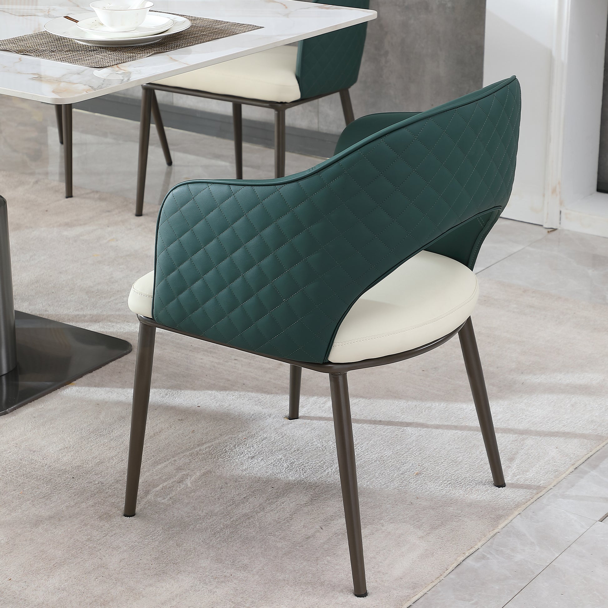 Quilted emerald green leather dining chair with cream seat and dark metal legs