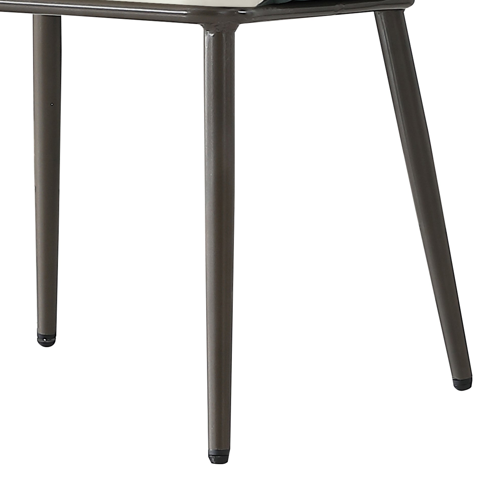 Four dark grey metal chair legs supporting a beige and green upholstered seat
