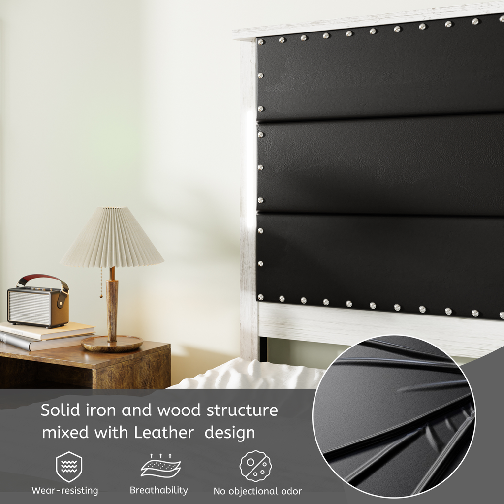 Black upholstered headboard with silver nailhead trim on distressed wood frame