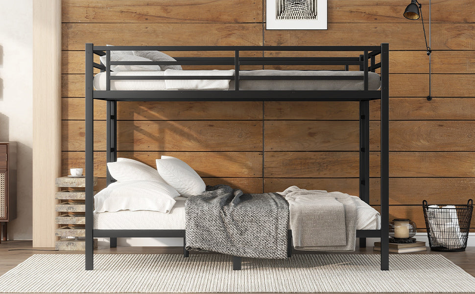 Black metal twin over twin bunk bed with white linens and grey blankets