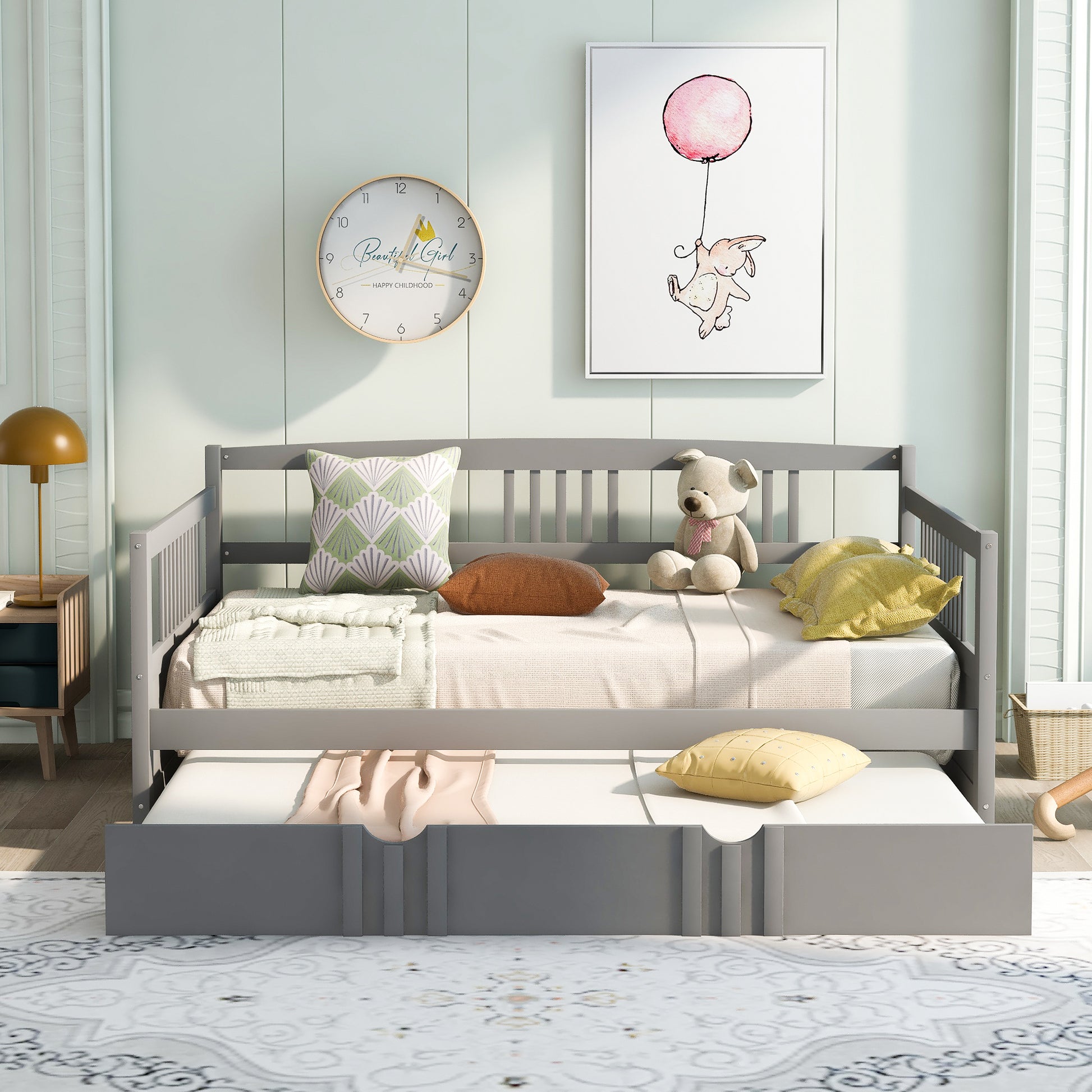 Gray wooden daybed with trundle plush bear and decorative pillows
