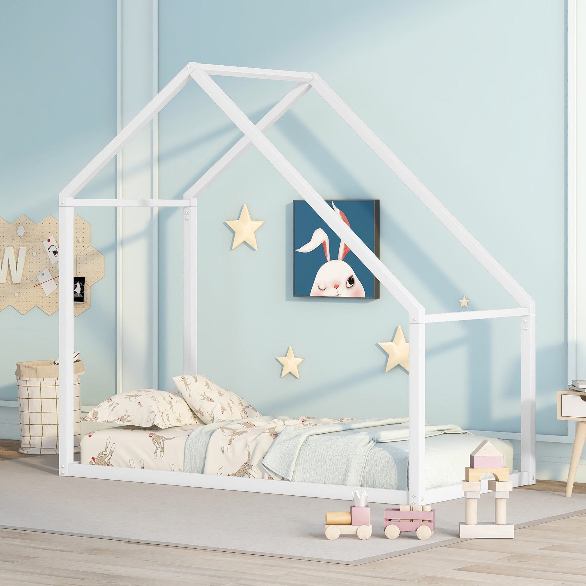 White wooden house bed frame with playful bedding and bunny art