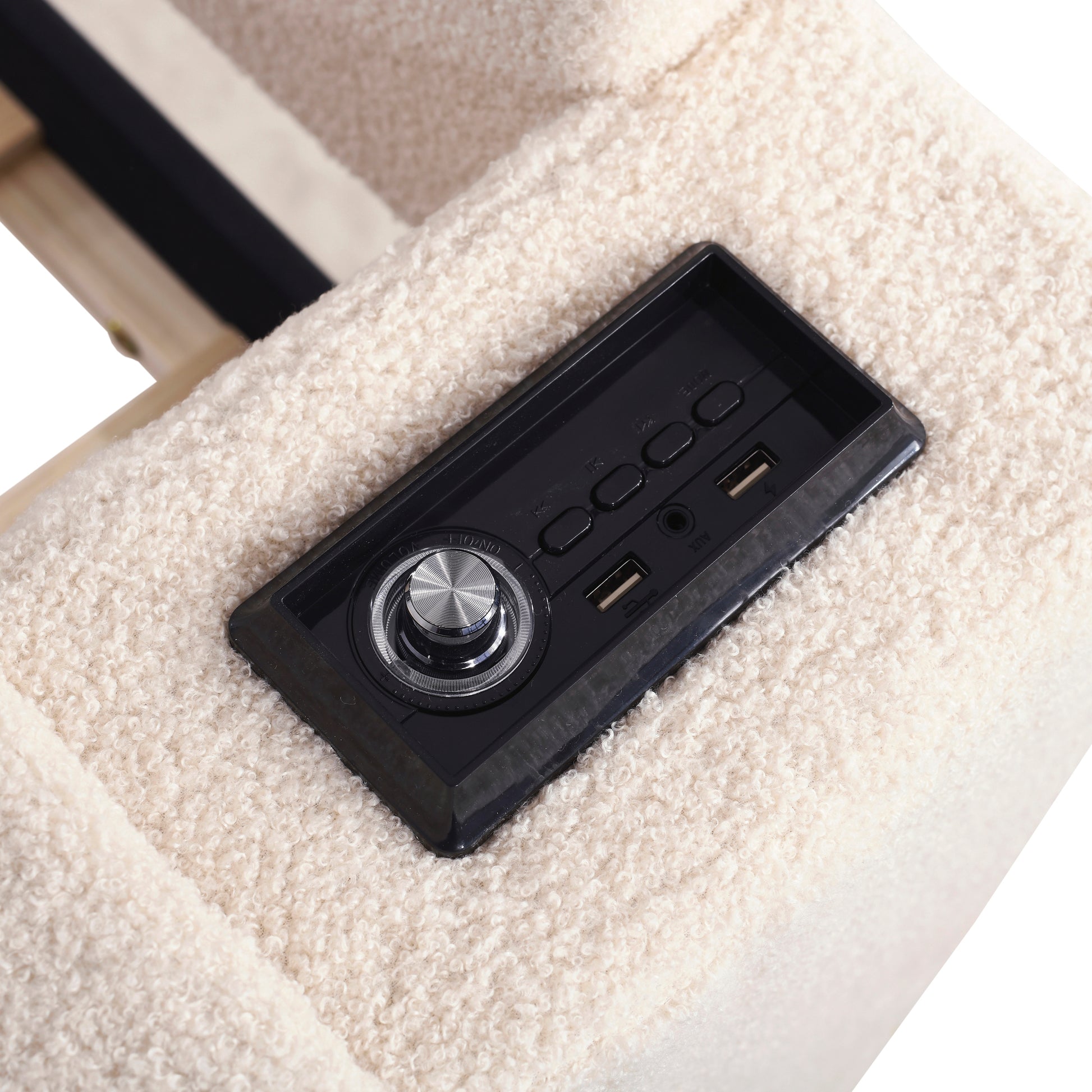 Integrated speaker controls with USB ports on a cream boucle fabric chair
