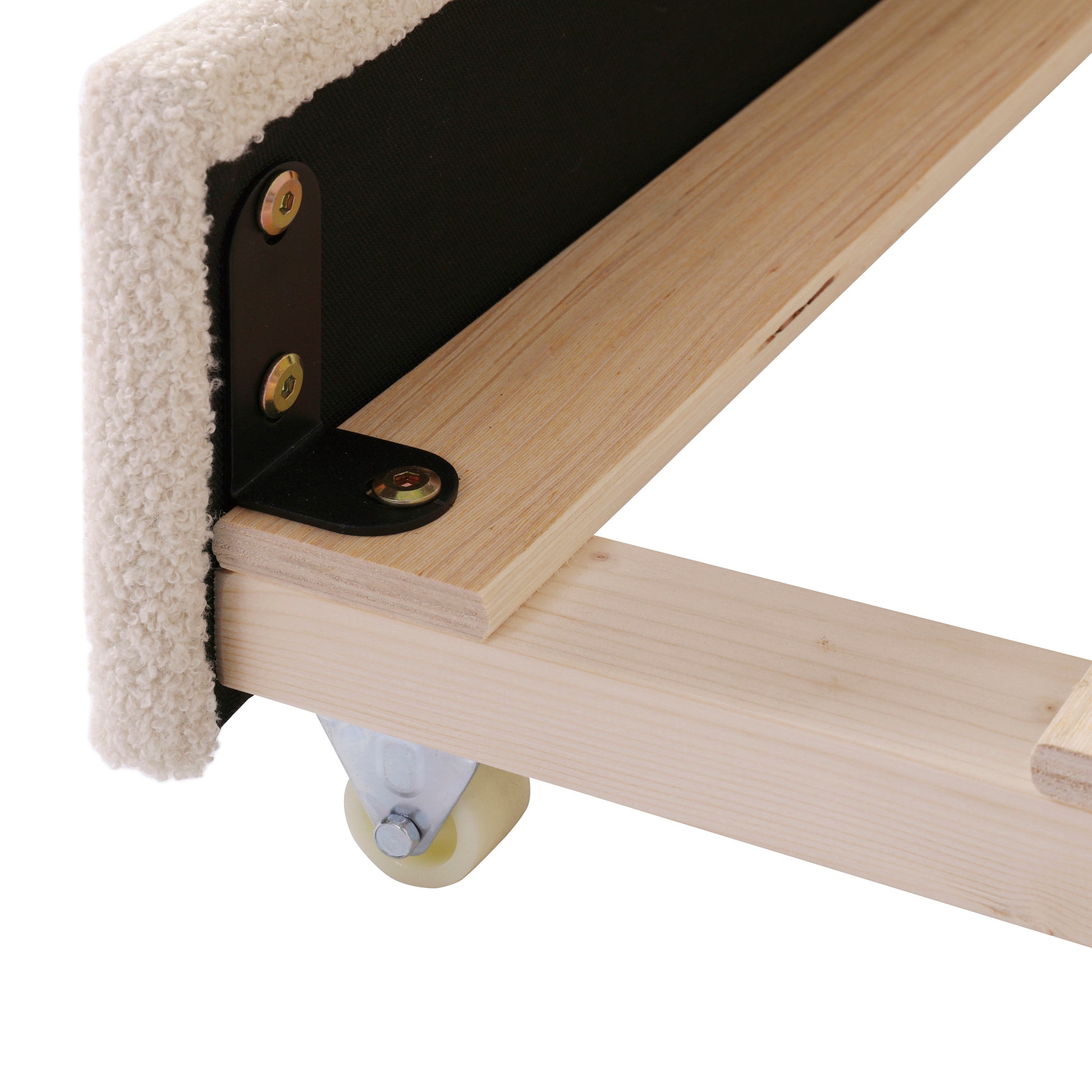 Closeup of white sherpa fabric edge secured to wood frame with black bracket and screws