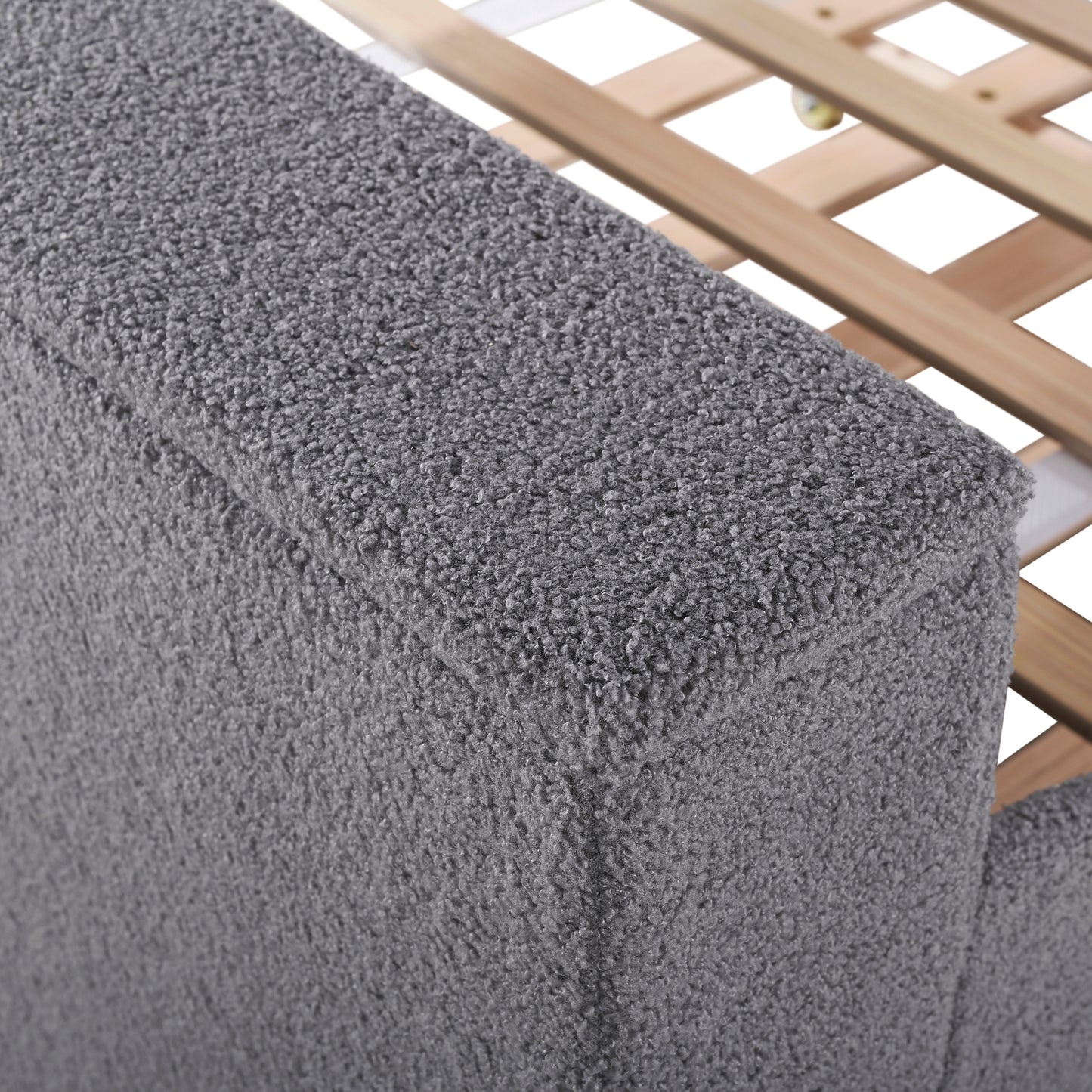 Closeup of plush grey fabric texture on a bed frame