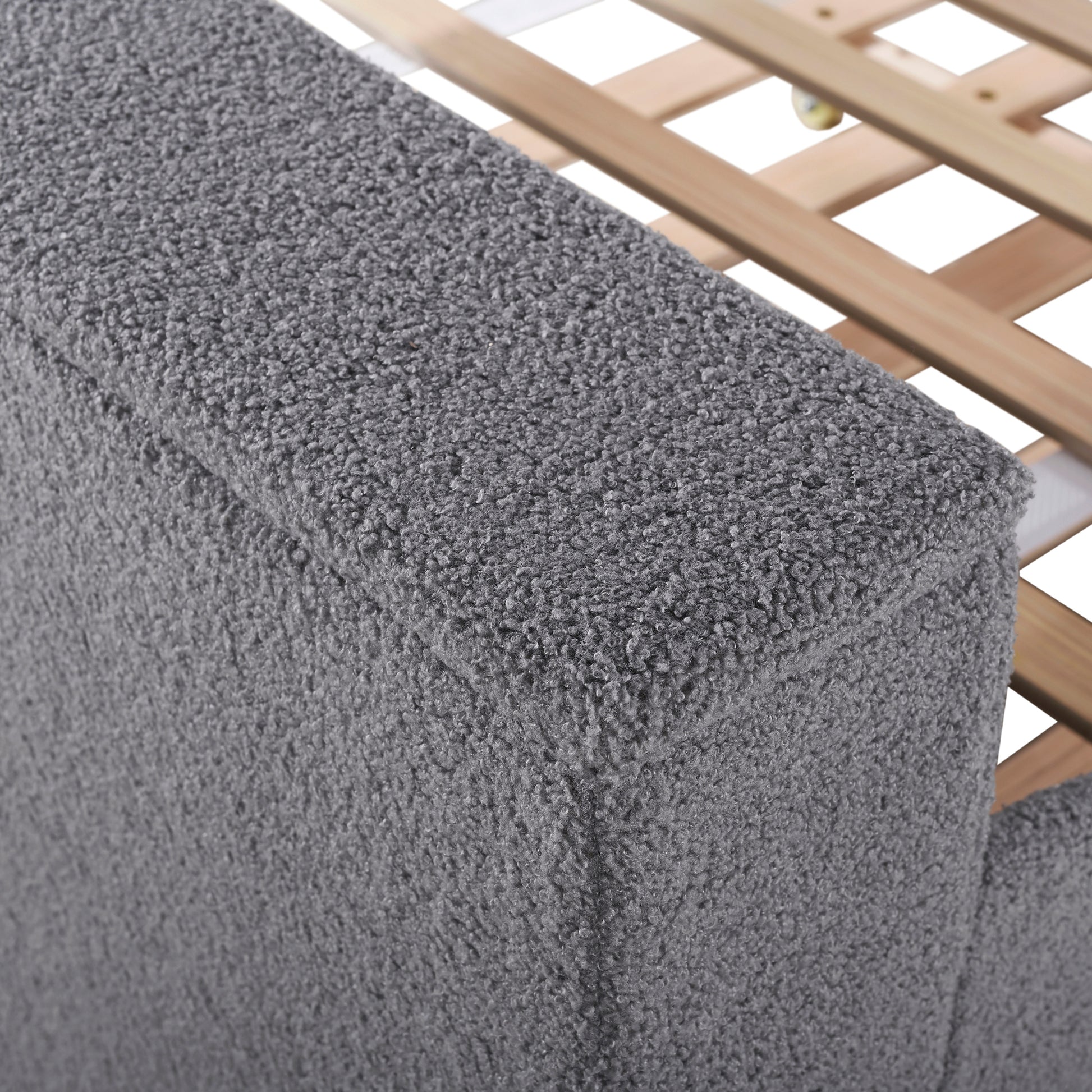 Closeup of plush grey fabric texture on a bed frame