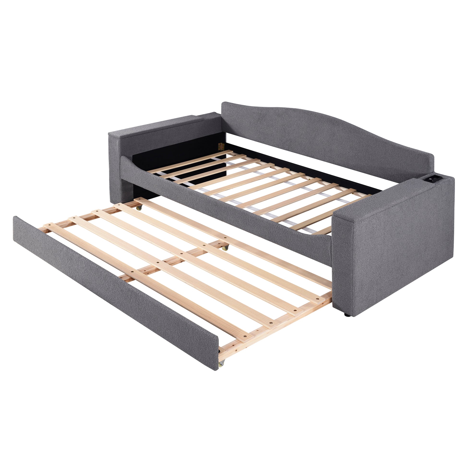 Grey upholstered sofa bed with pullout trundle frame exposed