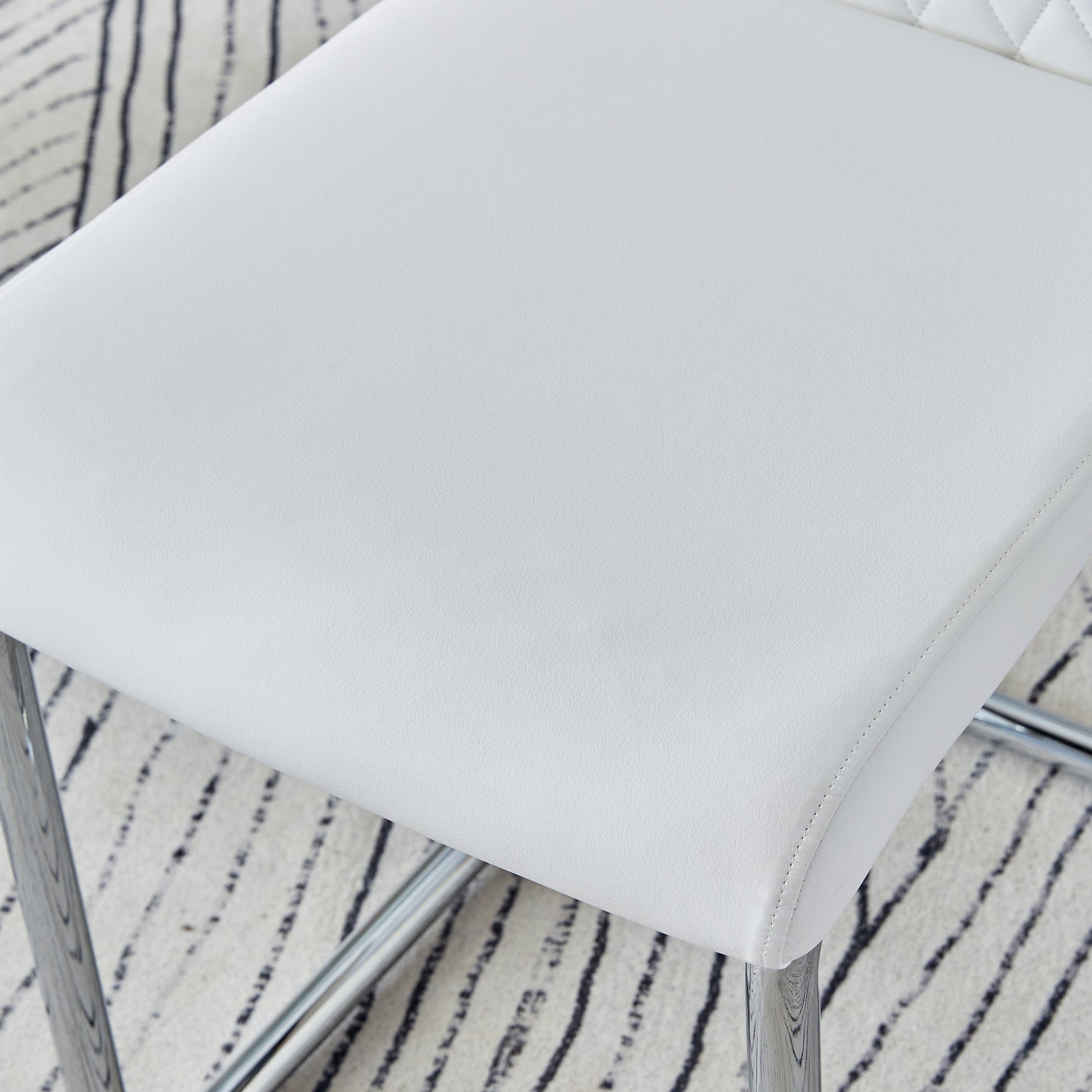 White leather dining chair seat with chrome legs and stitched detail