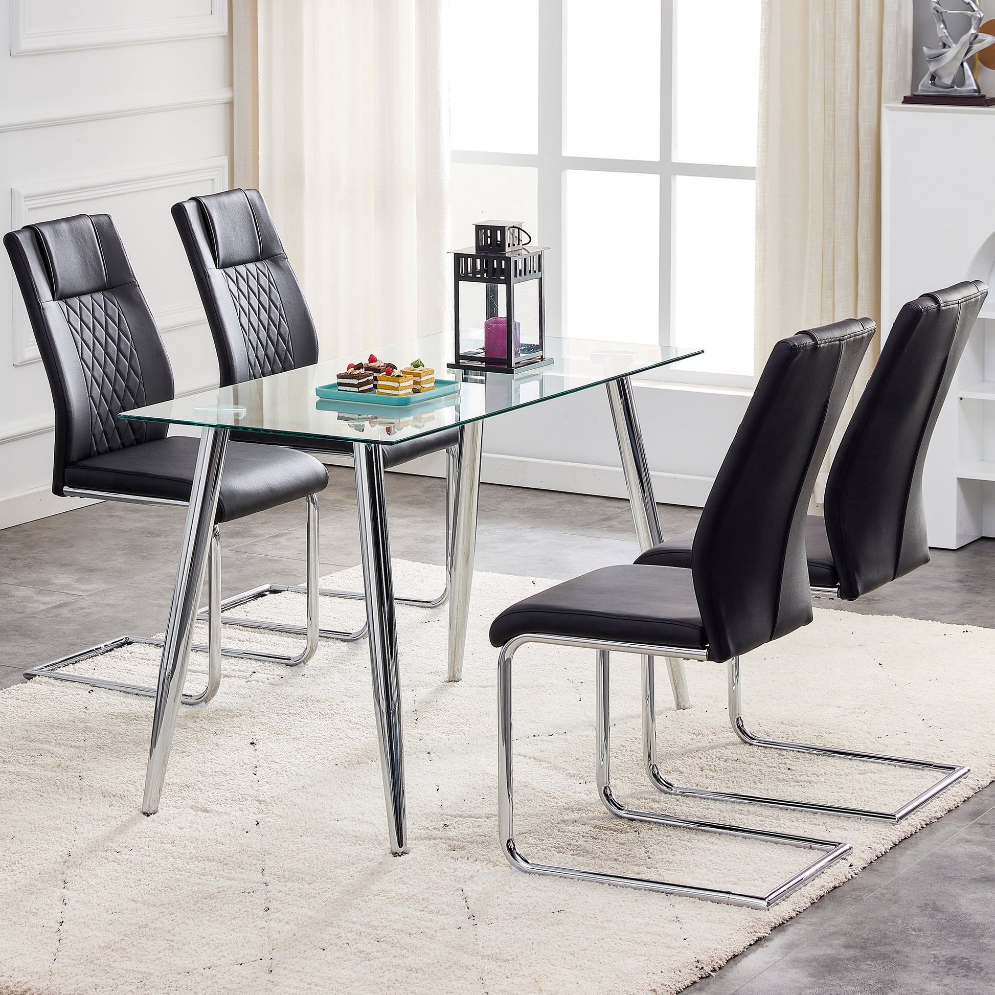 Black faux leather dining chairs with chrome cantilever bases and diamond stitching