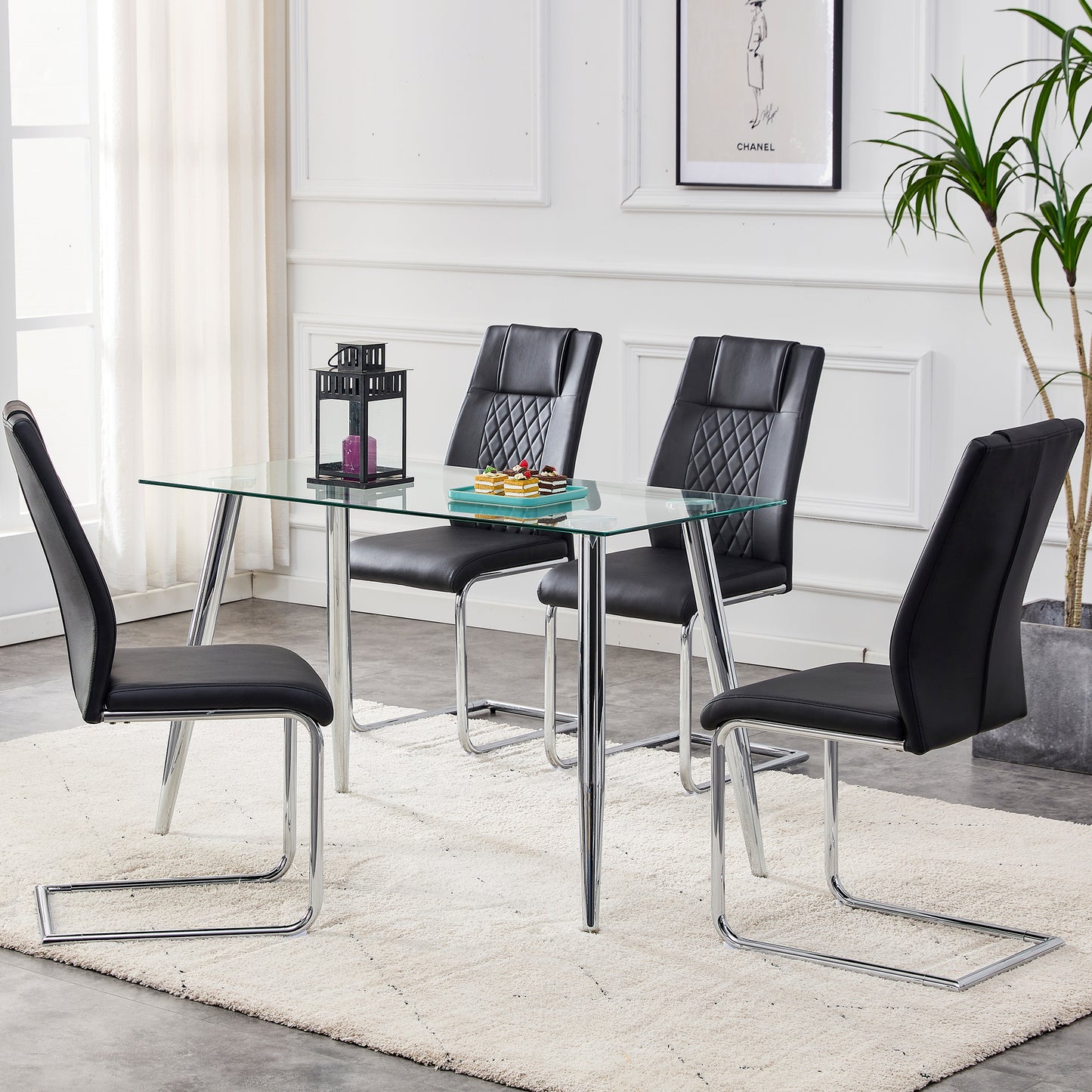 Modern glass dining table with four black leather cantilever chairs