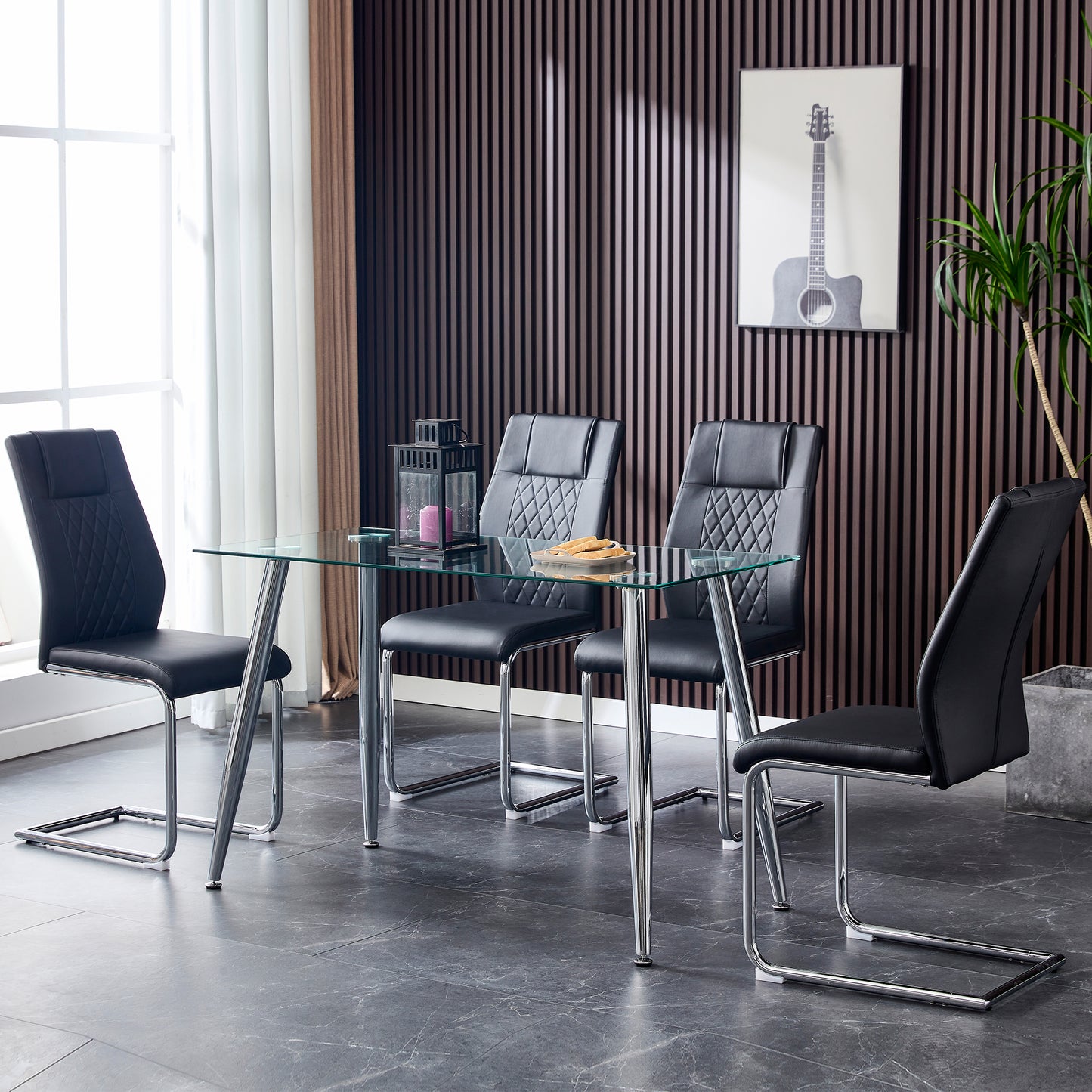 Modern black faux leather dining chair with diamond stitching and chrome sled legs