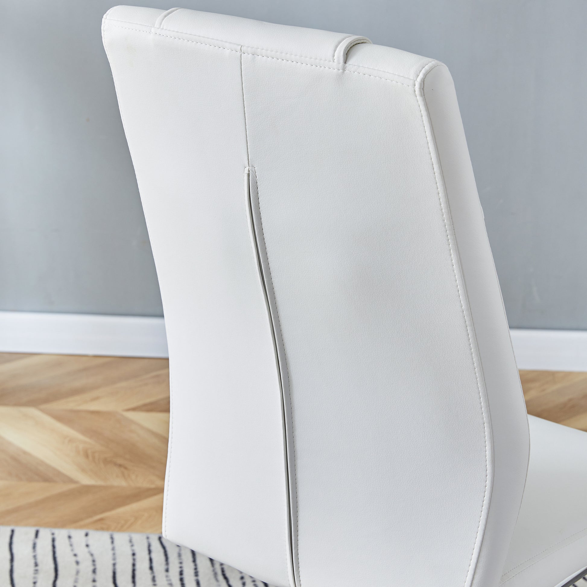 White faux leather dining chair back with stitched detail