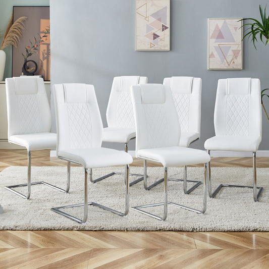 White faux leather dining chairs with diamondstitched backs and chrome sled legs