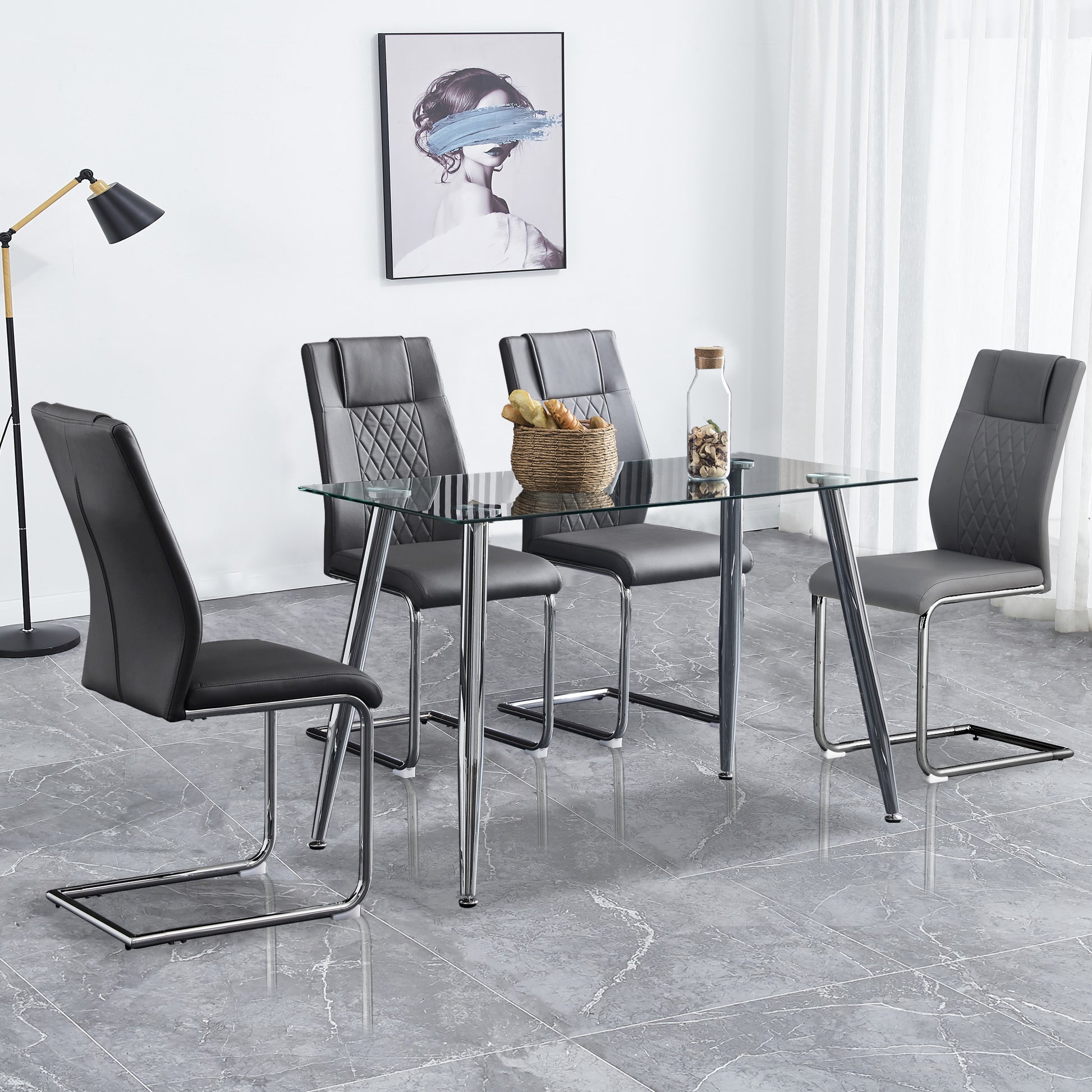 Modern glass dining table with four grey faux leather chairs