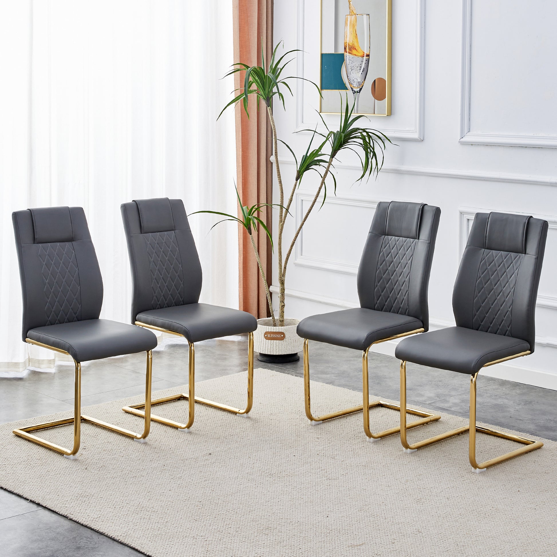 Set of four grey faux leather dining chairs with diamond stitching and gold sled legs