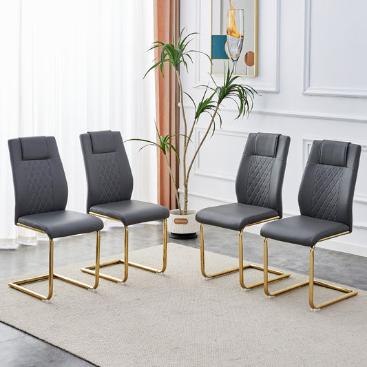 Set of four grey faux leather dining chairs with diamond stitching and gold sled legs