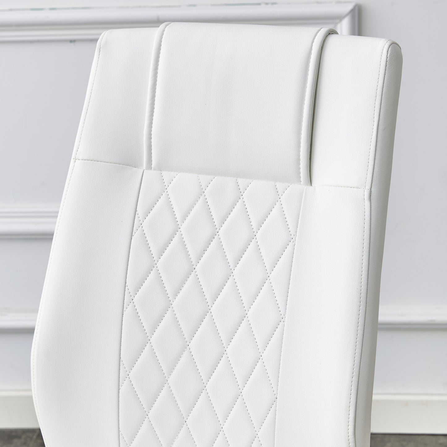 White faux leather office chair back with diamond stitching