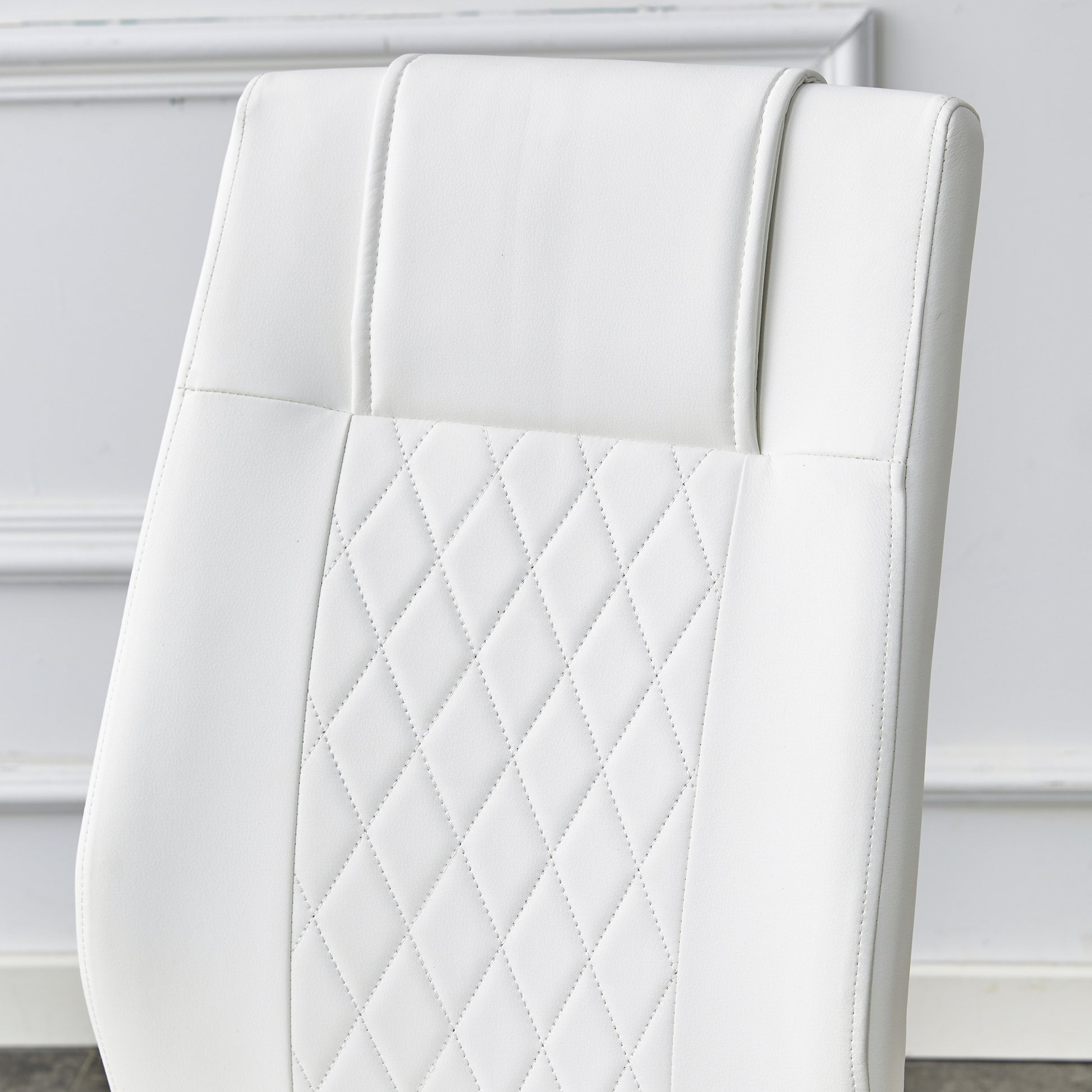 White faux leather office chair back with diamond stitching