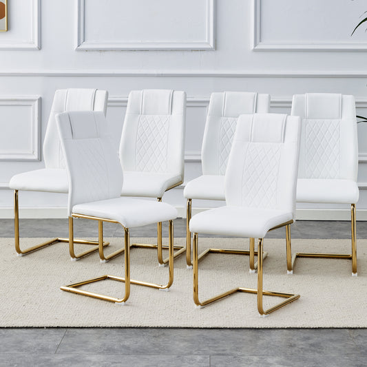 White leather dining chairs with diamond tufting and gold sled base