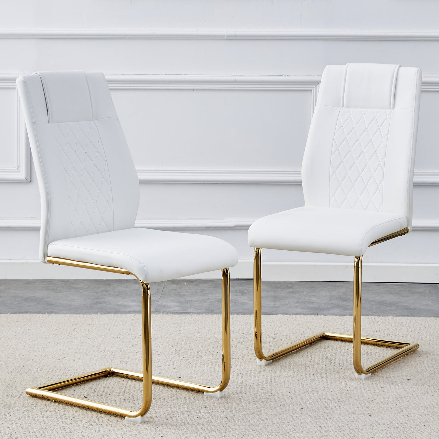 White faux leather dining chairs with gold sled base