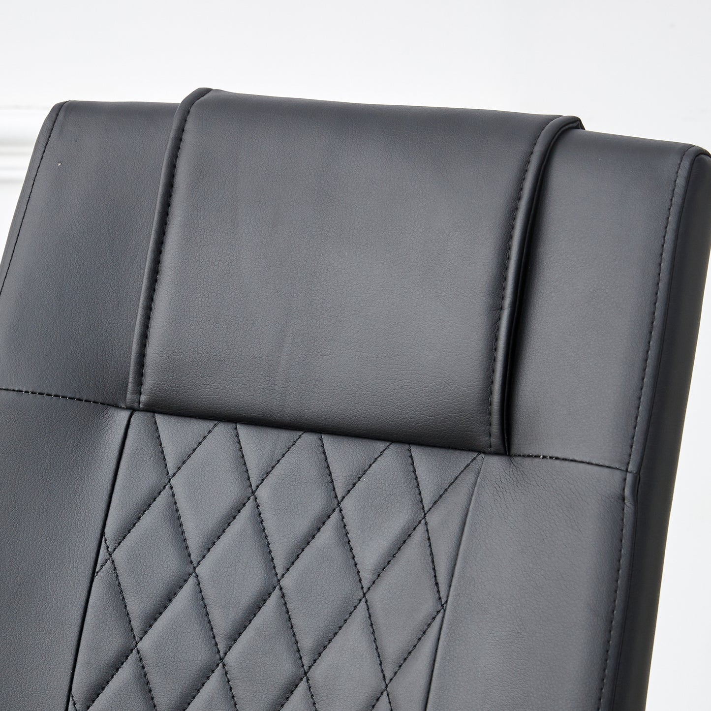 Black faux leather executive chair headrest with diamond stitching