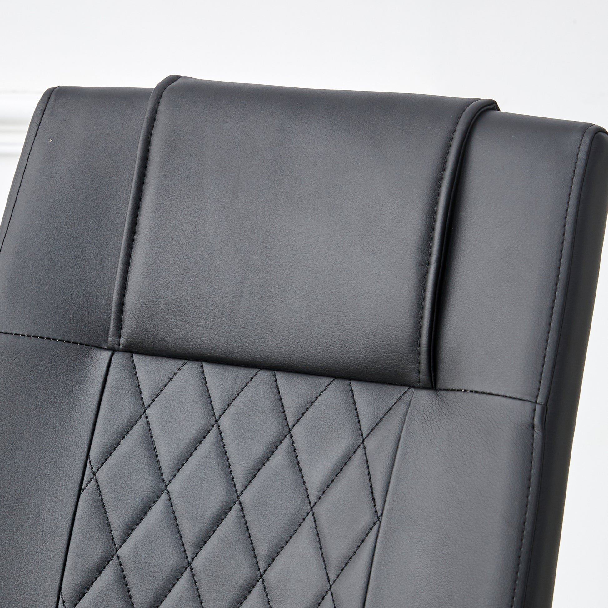 Black faux leather executive chair headrest with diamond stitching