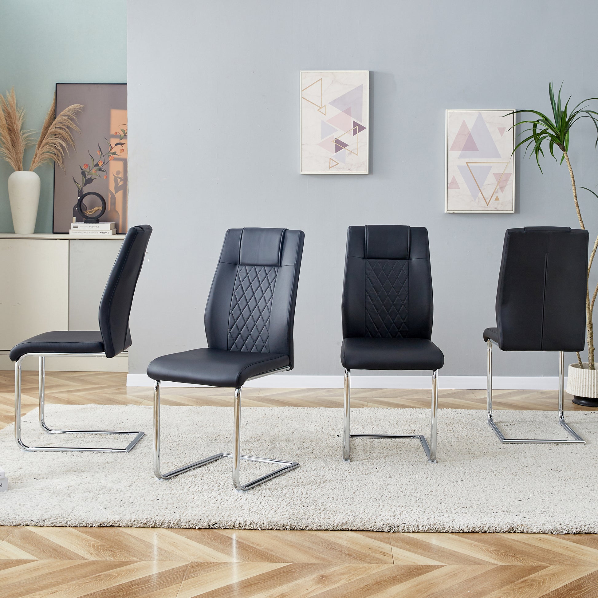 Black faux leather dining chair with diamond stitching detail and chrome cantilever base