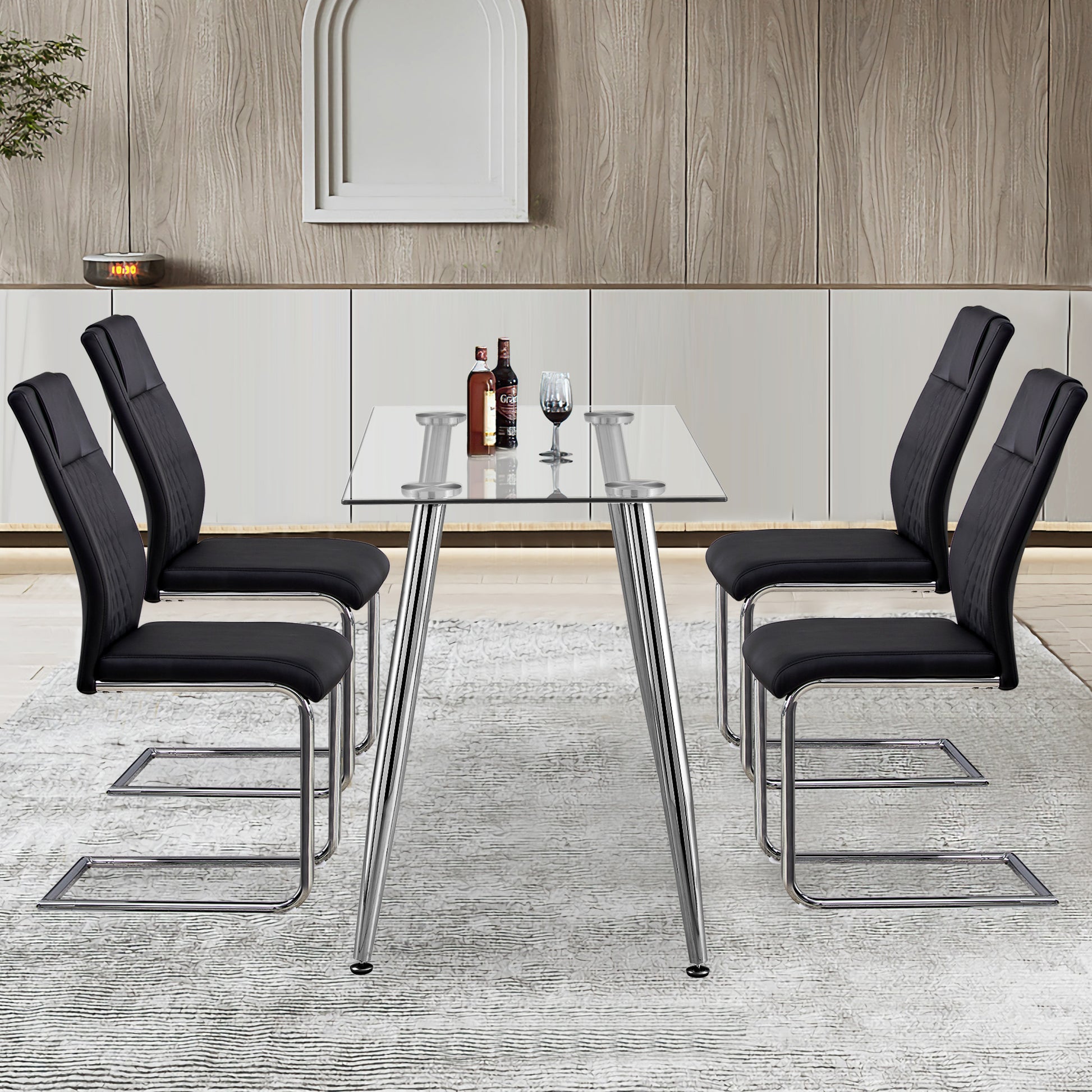 Modern glass dining table with four black faux leather chairs