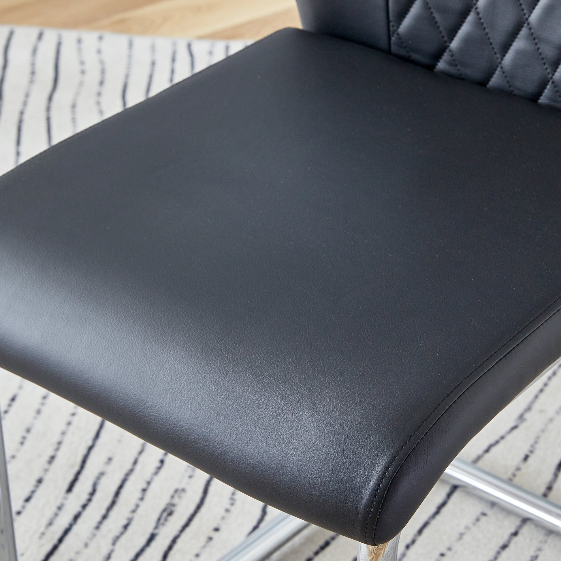 Black faux leather bar stool seat with diamond stitching detail