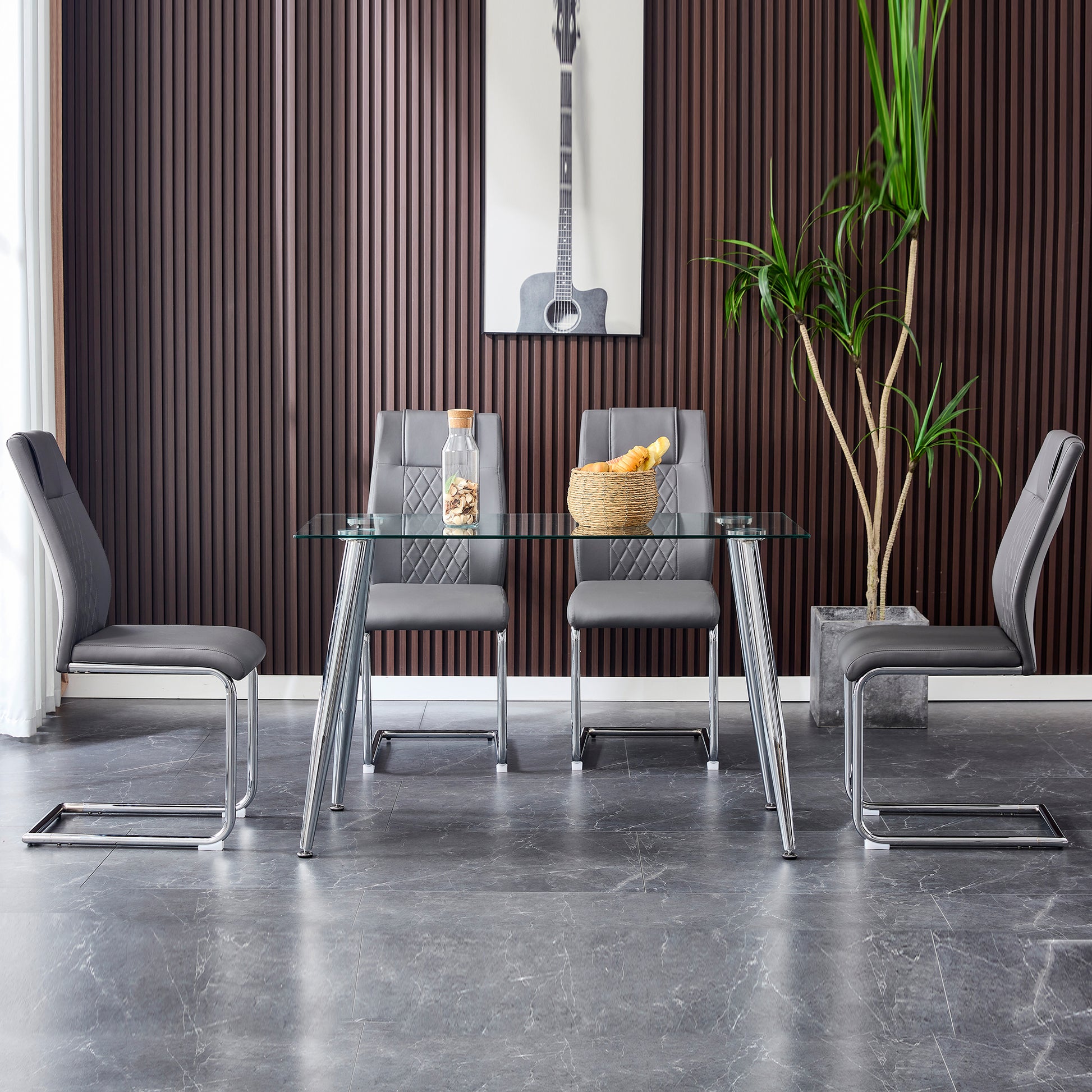 Grey faux leather dining chairs with quilted detail and chrome legs