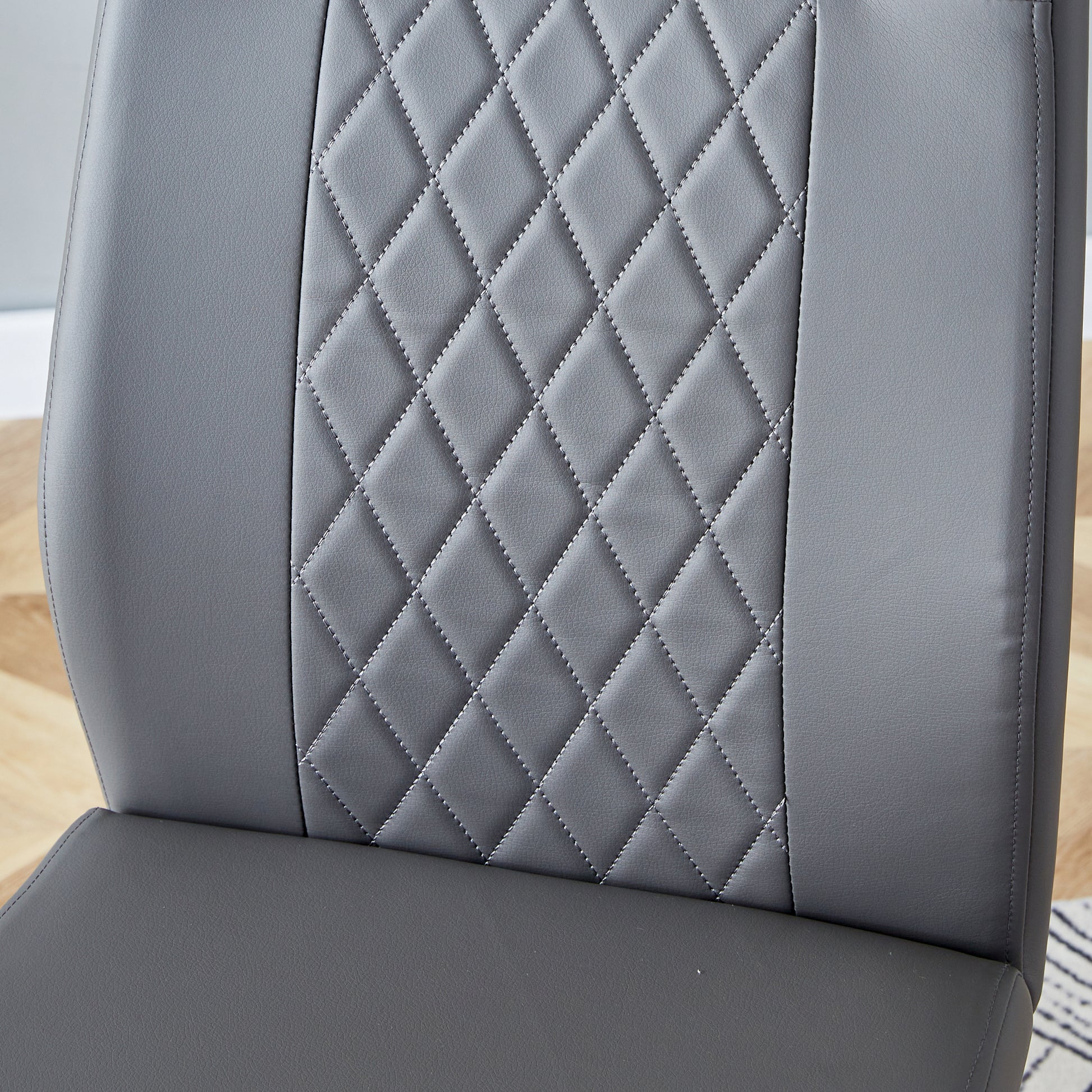 Grey faux leather dining chair with diamond stitching detail