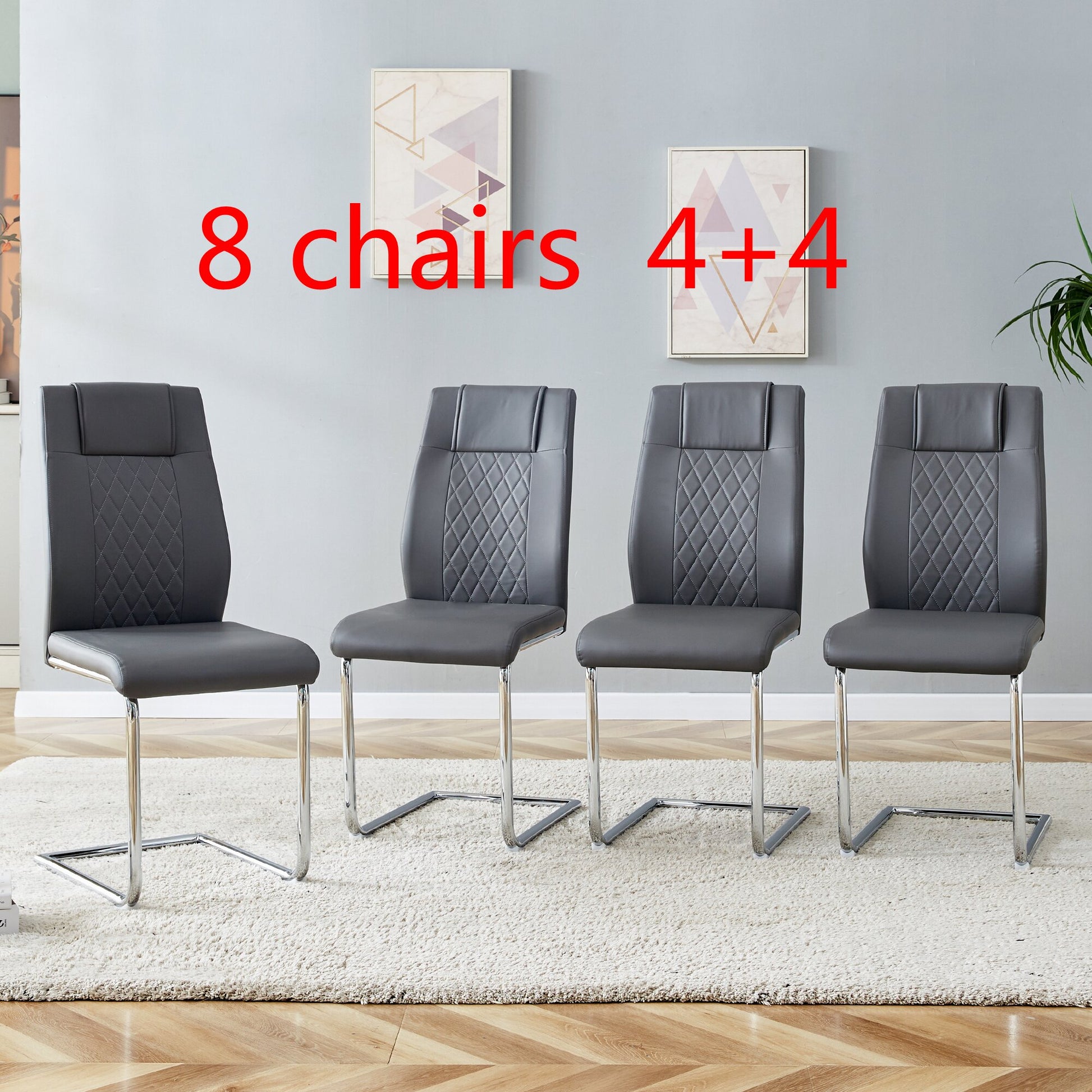 Four dark grey faux leather dining chairs with chrome sled legs and diamond stitching detail