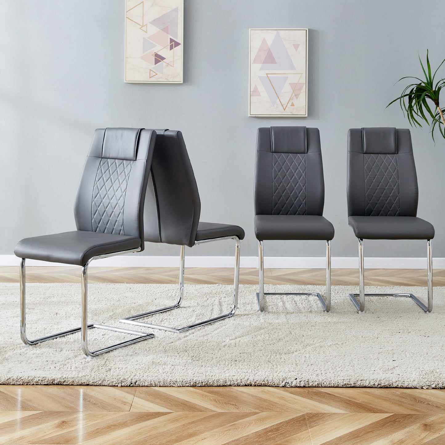Set of  modern grey faux leather dining chairs with chrome sled bases and diamond stitching