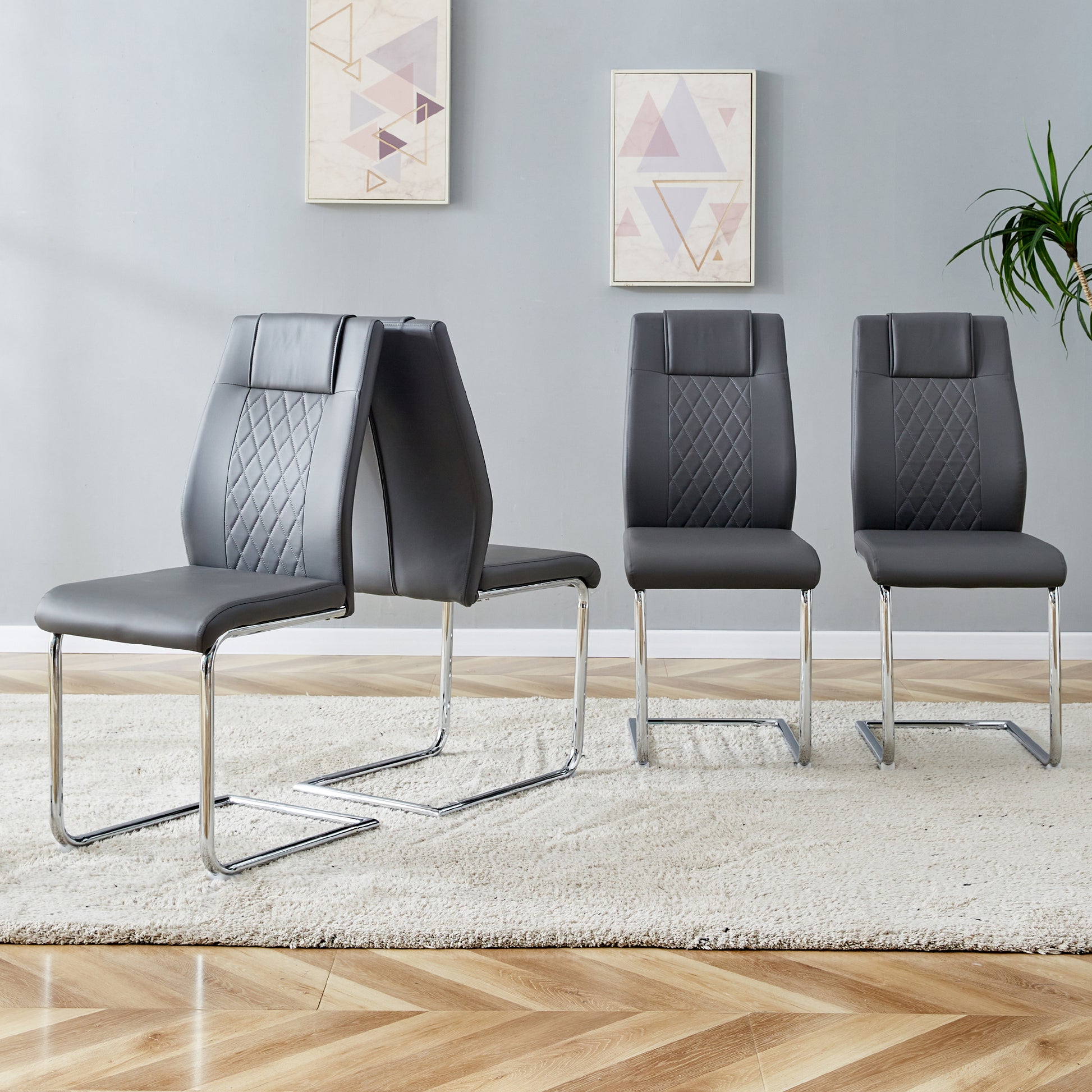 Set of  modern grey faux leather dining chairs with chrome sled bases and diamond stitching