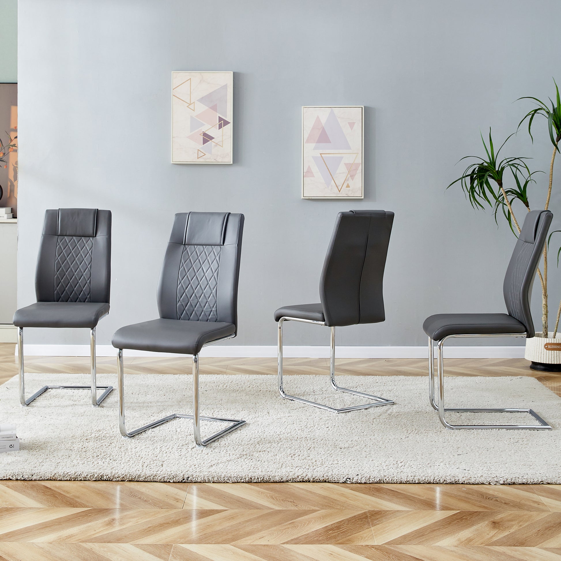 Gray faux leather dining chairs with diamond stitching and chrome sled legs