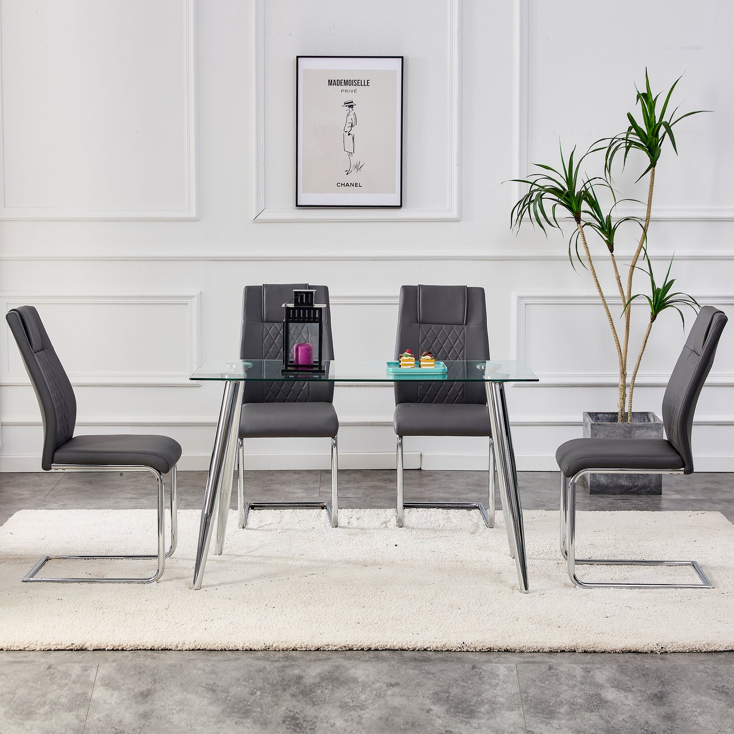 Modern glass dining table with four dark grey upholstered chairs