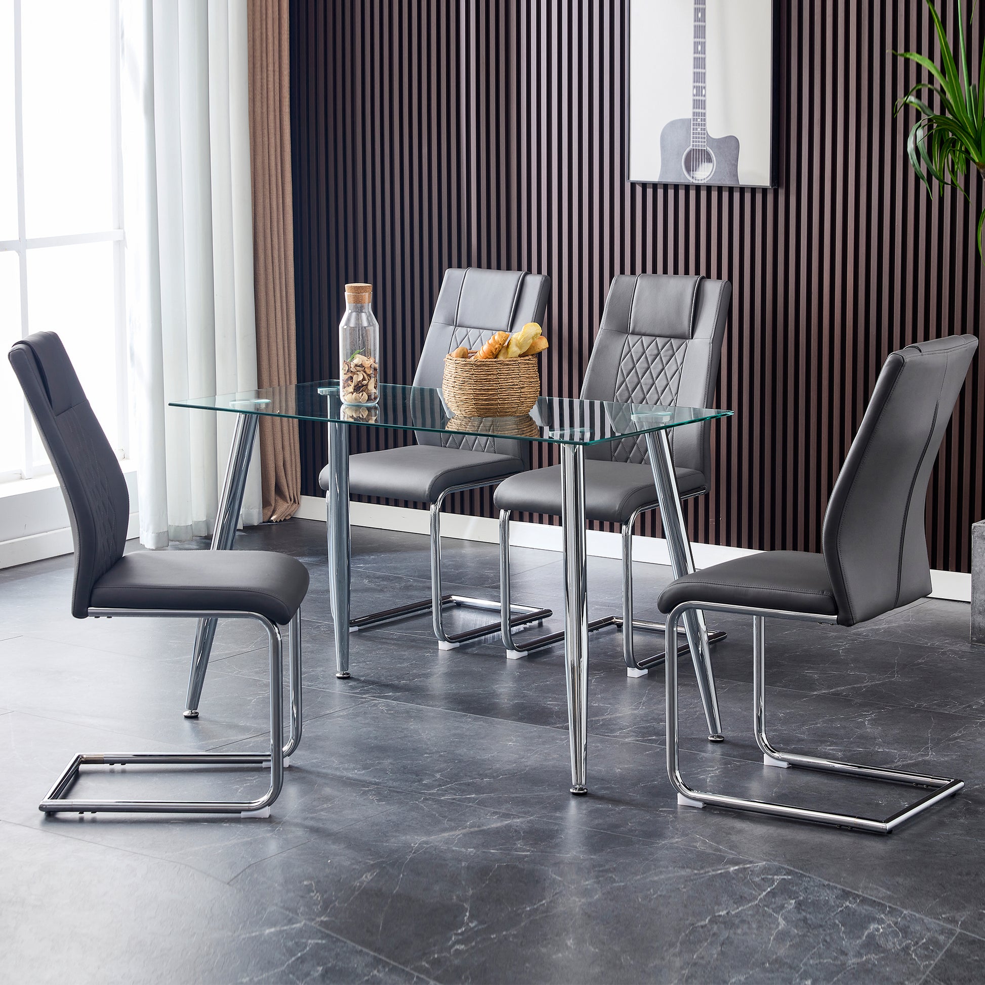 Modern dark gray dining chairs with quilted backrests and chrome cantilever legs