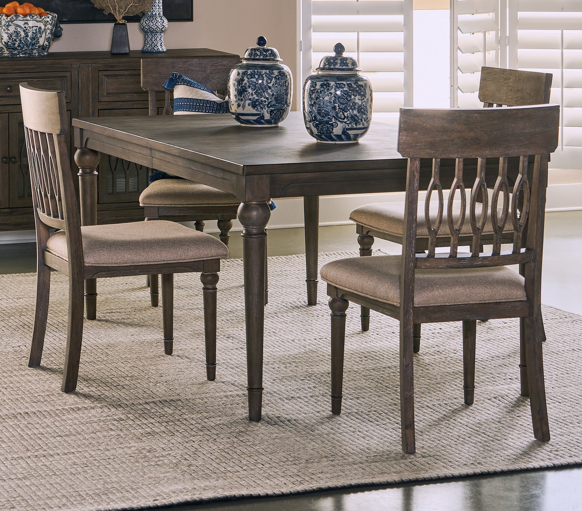 Dark oak dining table with upholstered chairs