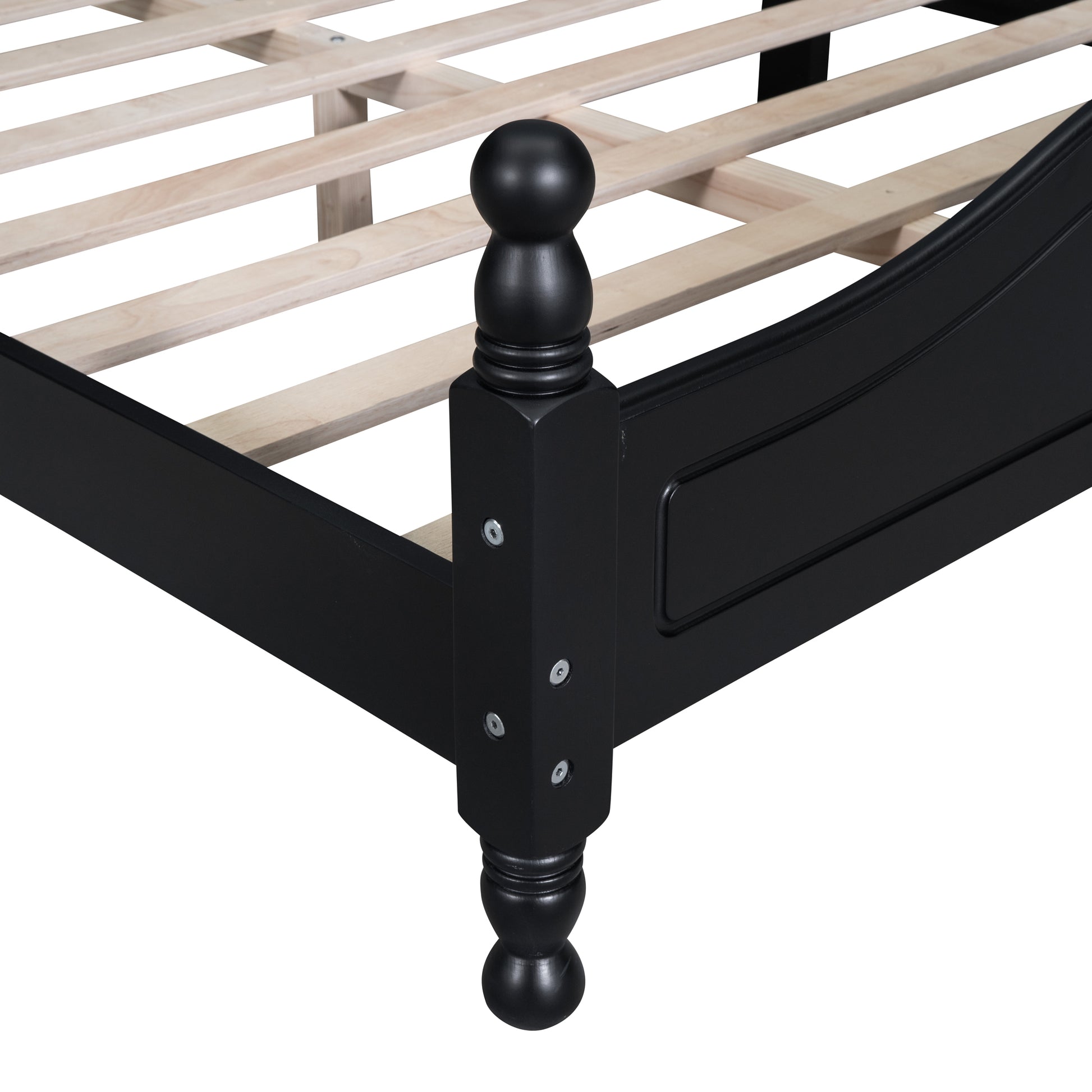 Black wooden bed frame detail with slatted base and turned leg post
