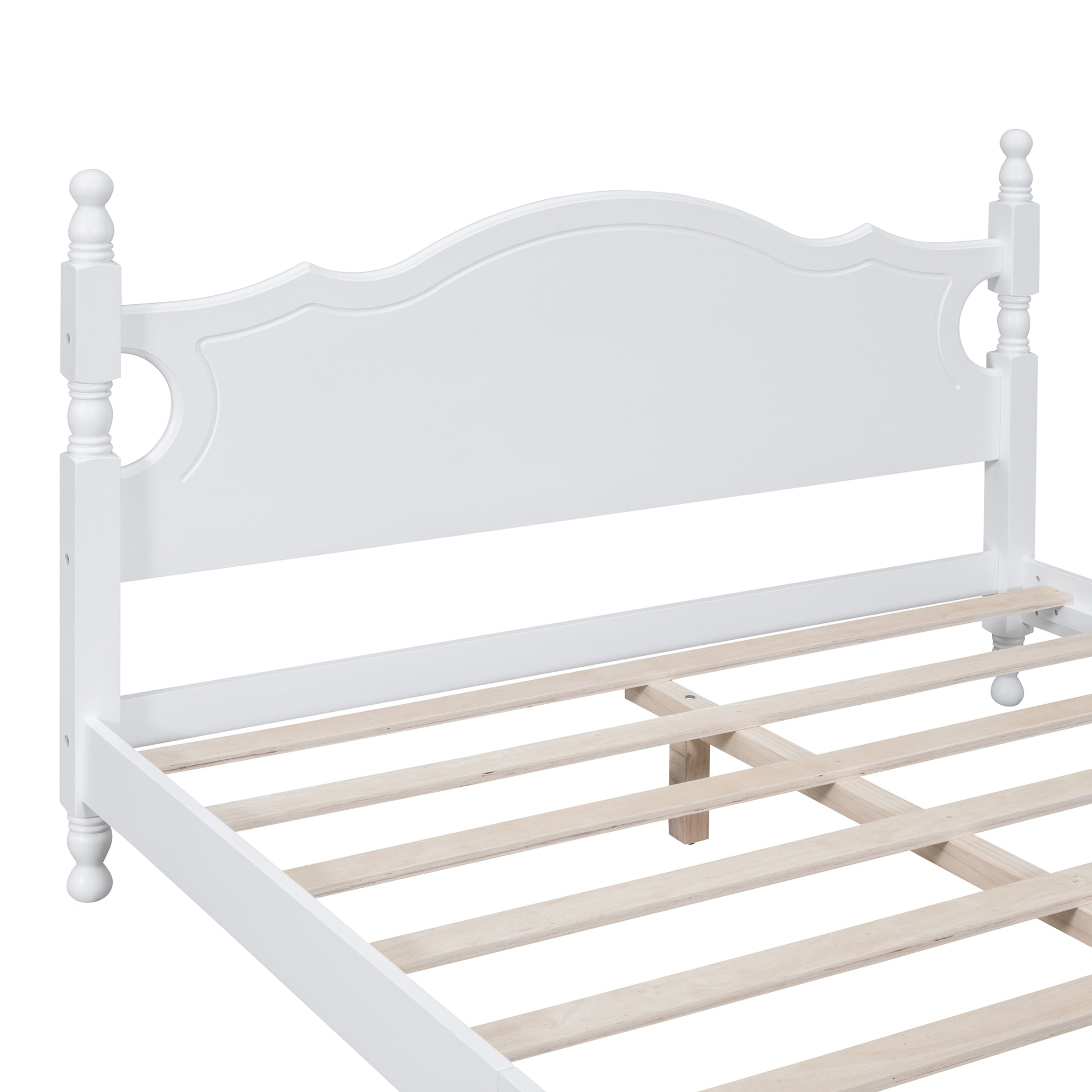 White wooden bed frame with a decorative headboard and slatted base
