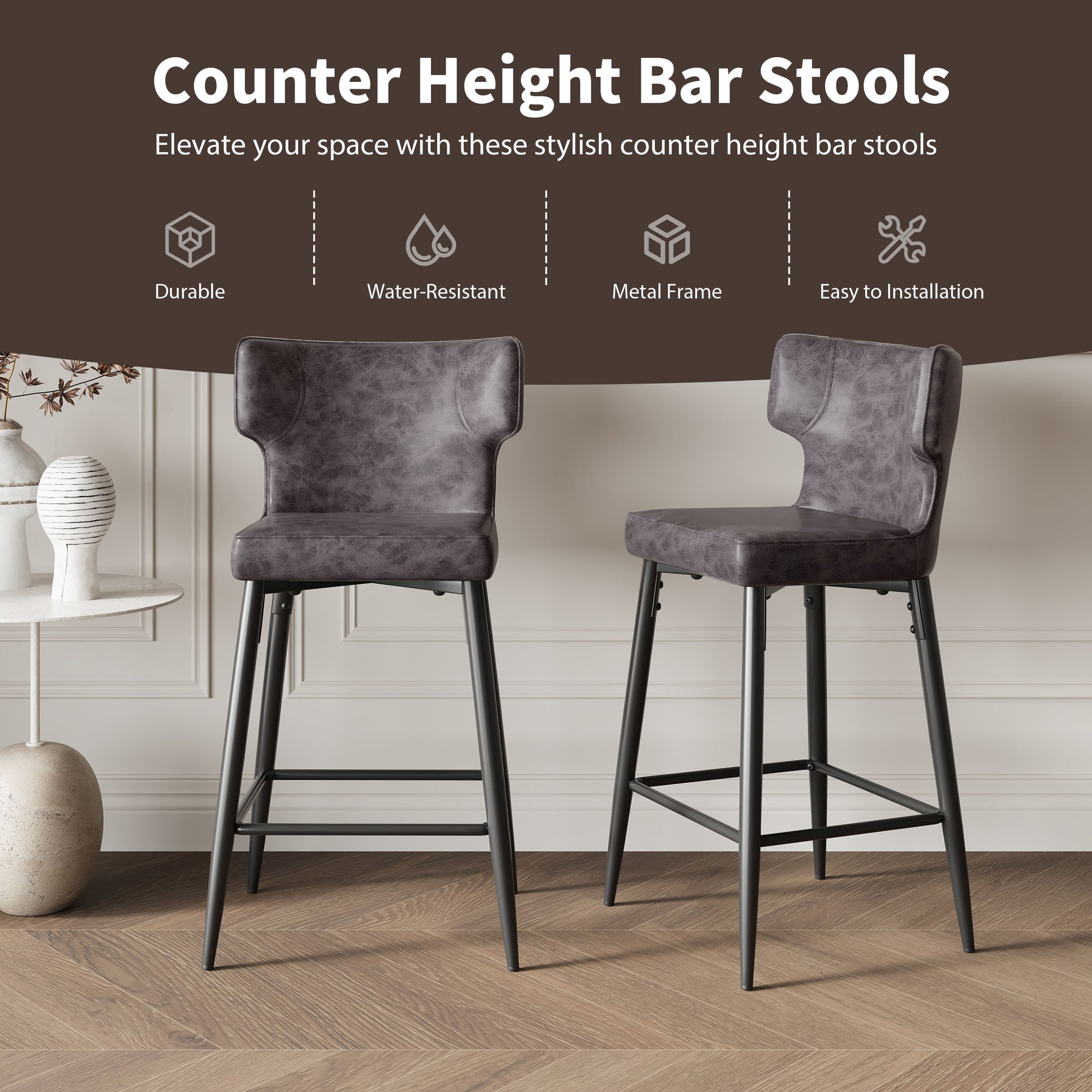 Two grey faux leather counter height bar stools with black metal legs